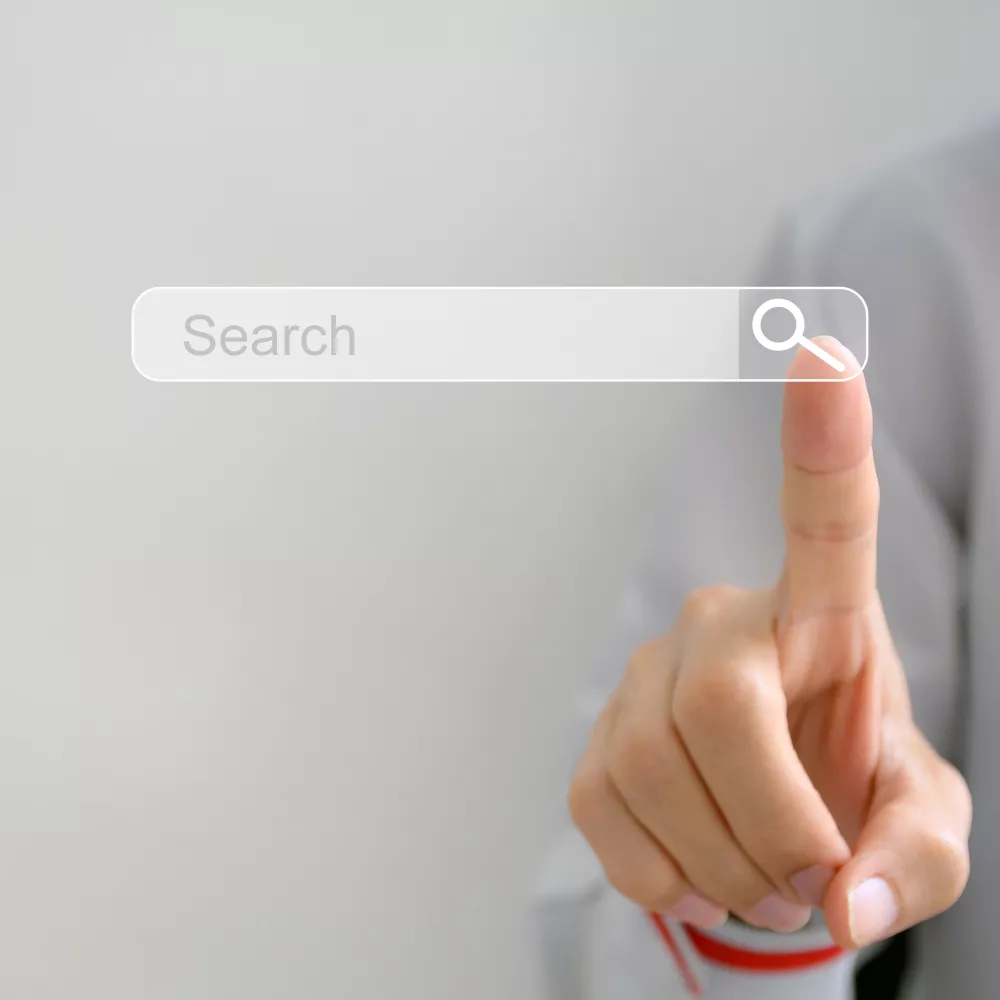 a finger clicking a search button